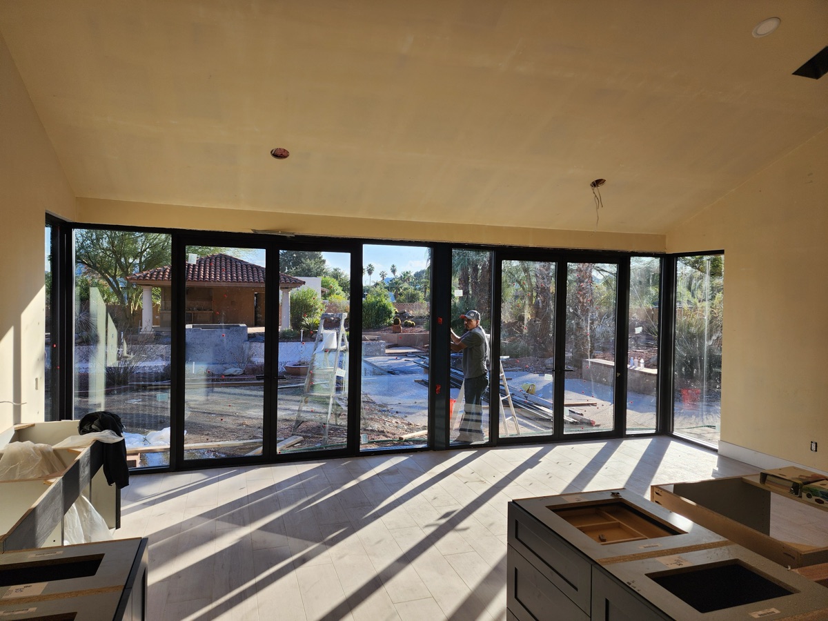 Multi-panel folding glass wall, interior install by Mad Touch Glass