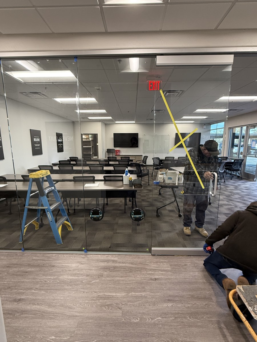 Commercial frameless glass partition wall install by Mad Touch Glass