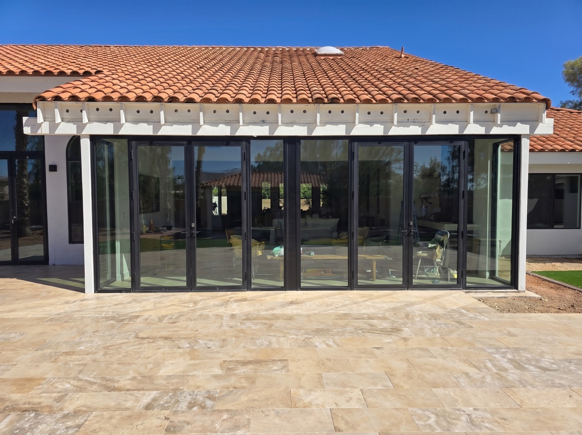 Multi-panel black-frame folding glass wall by Mad Touch Glass