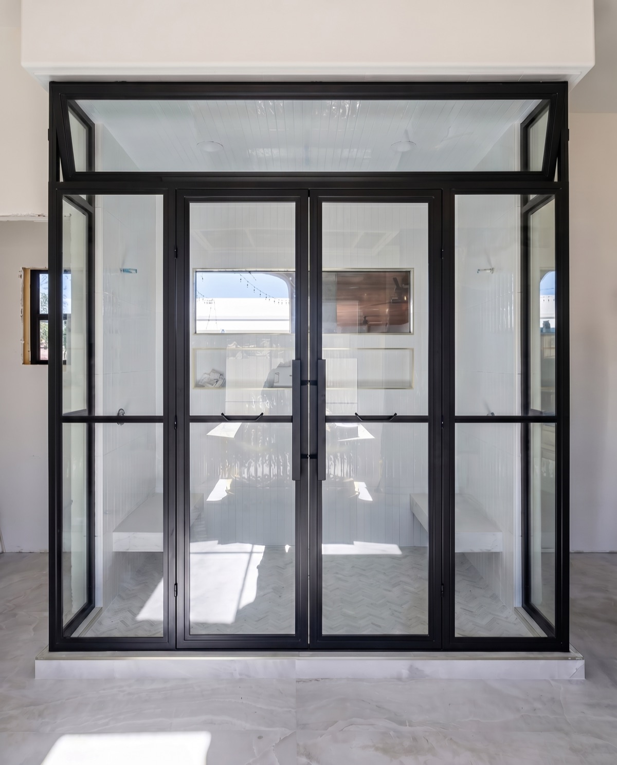 Black steel-grid glass shower enclosure by Mad Touch Glass