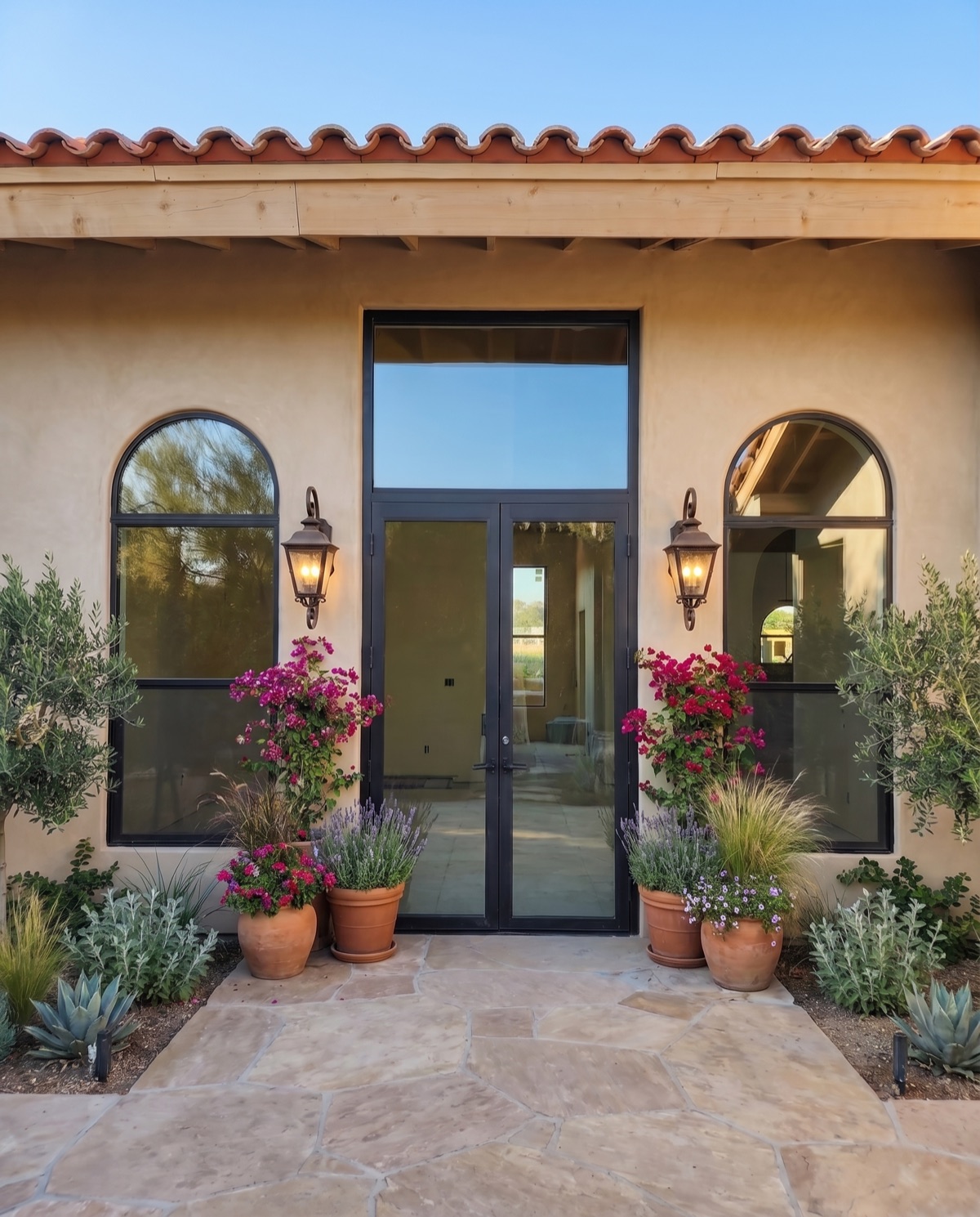 Black-frame entry door and arched windows by Mad Touch Glass